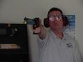 Photograph: [Steve Swartz poses with air pistol, 1]
