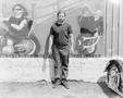 Photograph: [Photograph of a biker standing in front of a mural]