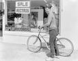 Photograph: [Photograph of a man standing with his bike]