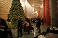 Photograph: [Guests and Christmas tree in foyer at Sounds of the Holidays]