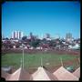 Photograph: [A field and buildings in Campo Grande]