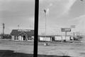 Photograph: [A computer store and a parking lot]