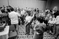 Primary view of [Churchgoers bless each other during service, 2]