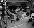 Photograph: [Mike Evans and others sit in living room, 1]