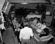 Photograph: [Mike Evans and others sit in living room, 5]