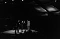Photograph: [Mike Evans on stage with two others, 3]