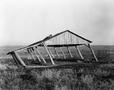 Photograph: [Photograph of the leaning frame of a barn]