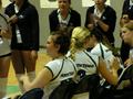 Photograph: [UNT volleyball players converse on the sidelines during 2006 Sun Bel…