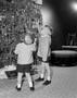 Photograph: [Jim and John Foster standing in front of a Christmas tree]