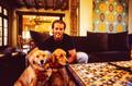 Photograph: [Mike Modano posing with his two golden retrievers]