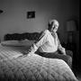 Photograph: [Portrait of Man Sitting on a Bed, 2]
