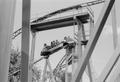 Photograph: [An amusement ride with passengers riding down curving tracks at Six …