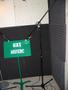 Photograph: [A green music stand sitting in a padded corner]