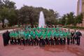 Photograph: [Trombone students and trombone faculty posing in front of a fountain…