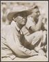 Photograph: [Man at a livestock show, wearing a cowboy hat]
