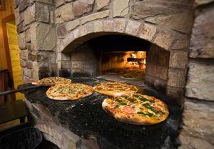 Primary view of object titled '[Savoring Tradition: Wood-Fired Pizza at Ancient Ovens, Saint Jo, Texas]'.