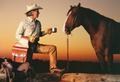 Primary view of [Cowboy posing with horse]