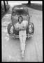 Photograph: [Man Posing in Front of a Beetle]