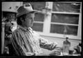 Photograph: [Man at a Kitchen Table in a Cowboy Hat]