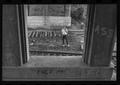 Photograph: [Man standing on an abandoned train track]