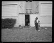 Photograph: [Mom and Child in front of House, 1988]