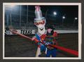 Photograph: [Tina Richey and mascot Sparky cutting a ribbon]