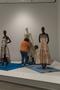 Primary view of [Janelle McCabe and Annette Becker placing a tan dress on mannequin]