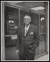 Photograph: [Man in a Suit in Front of Domino's Restaurant]