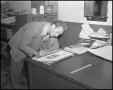 Photograph: [Male Class Officer Creating a Yucca Sign in an Office]