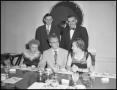Photograph: [Five people sitting at a formal dining table]