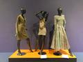 Photograph: [Three ensembles from the TFC's holdings on exhibit]
