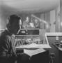 Photograph: [A man smoking in a recording room, 1]