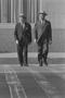 Photograph: [Two men walking across a road, 2]
