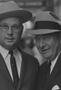 Primary view of [Close-up of two men in suits and hats, 7]