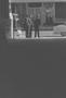 Primary view of [Distant view of men talking on a street, 2]