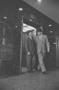 Photograph: [Two men leaving an elevator in Dallas, 5]