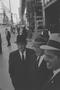 Photograph: [Three men conversing on a crowded sidewalk, 3]