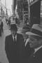 Photograph: [Three men conversing on a crowded sidewalk, 6]