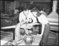 Photograph: [Two people working on an industrial arts project]