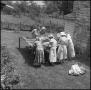 Photograph: [Women at an outdoor quilting bee]