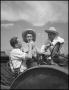 Primary view of [Two men and a woman on a tractor]