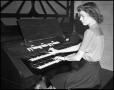 Photograph: [Woman playing the organ]