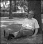 Photograph: [Photograph of Dr. Wayne Adams seated beneath tree]