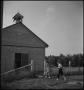 Photograph: [Boy and girl arriving at one room school]