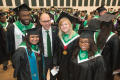 Photograph: [University president poses with students]