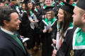 Primary view of [Neil Foote with students at UNT Commencement]