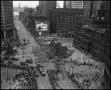 Photograph: [Aerial photograph of a parade marching downtown, 2]