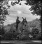 Photograph: [Young boy riding a donkey]