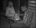 Photograph: [Aunt and Uncle Treece separating cotton seeds]