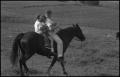 Photograph: [Photograph of a family riding their horse]
